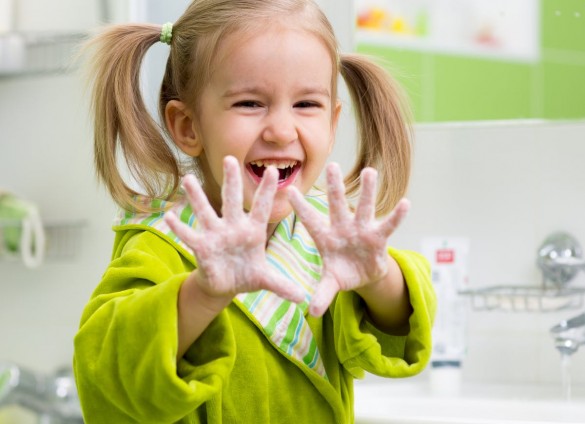 Child washing hands with soap