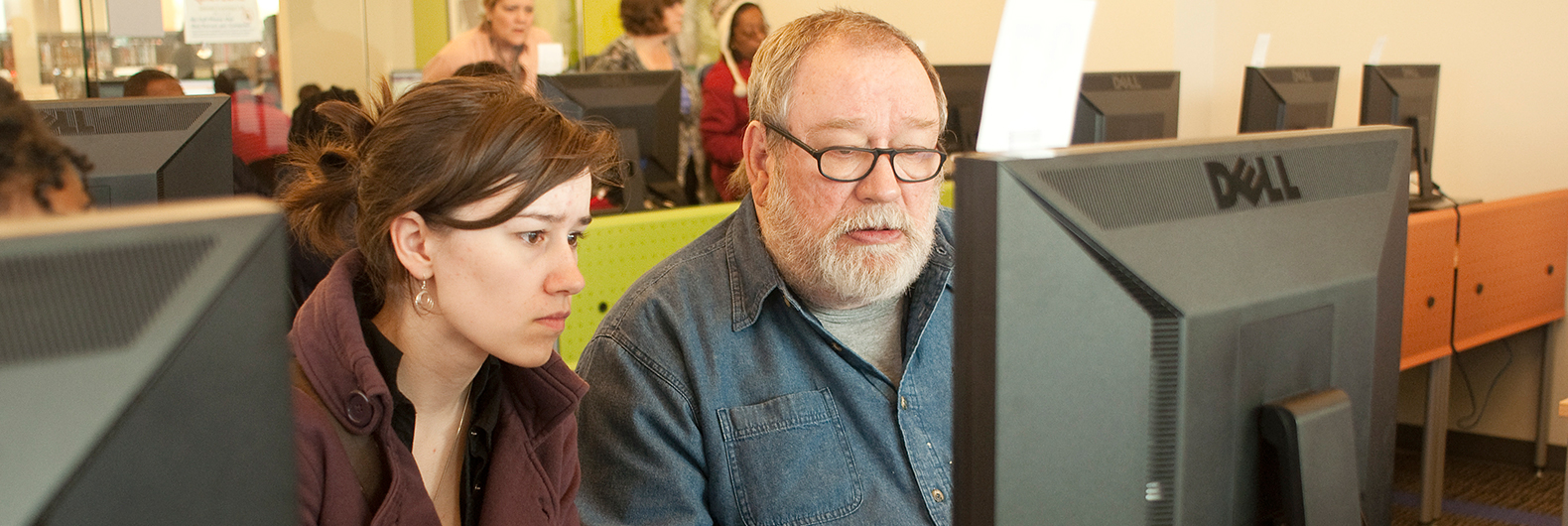 Teen and adult at computer at ImaginOn